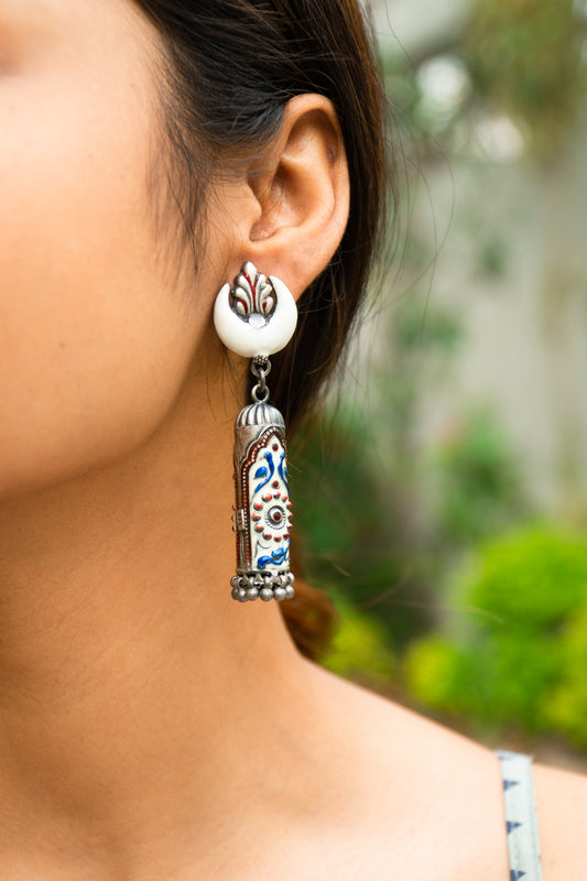 White Cylindrical Handcrafted Enamel Earrings With Ghungroo Hangings - UMANG